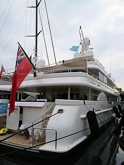 a boat with a flag on the front aboard DEJA TOO Yacht for Sale