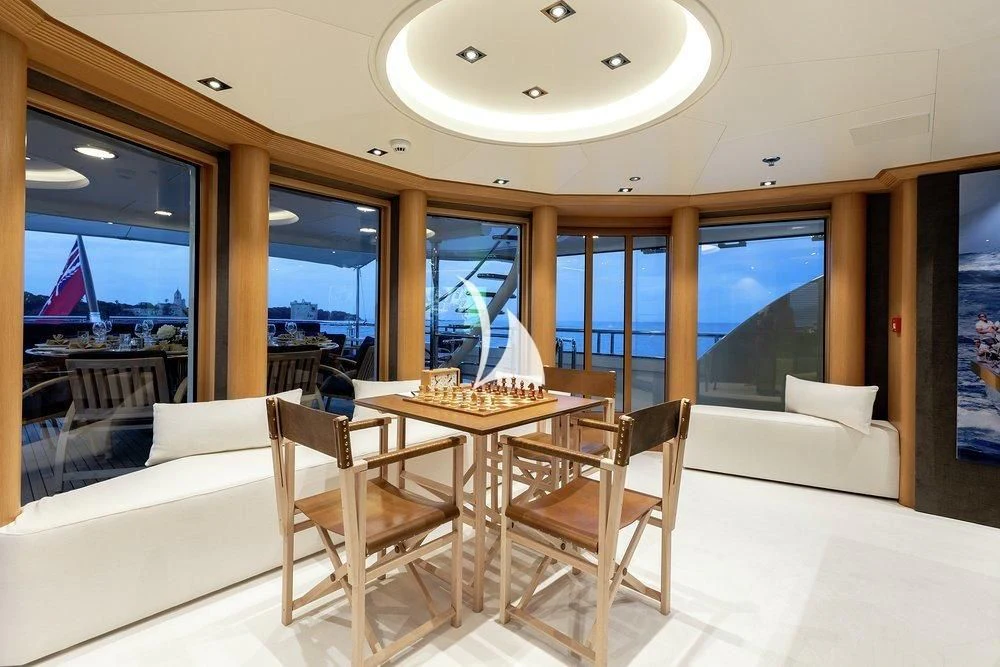 a room with a table and chairs aboard DEJA TOO Yacht for Sale
