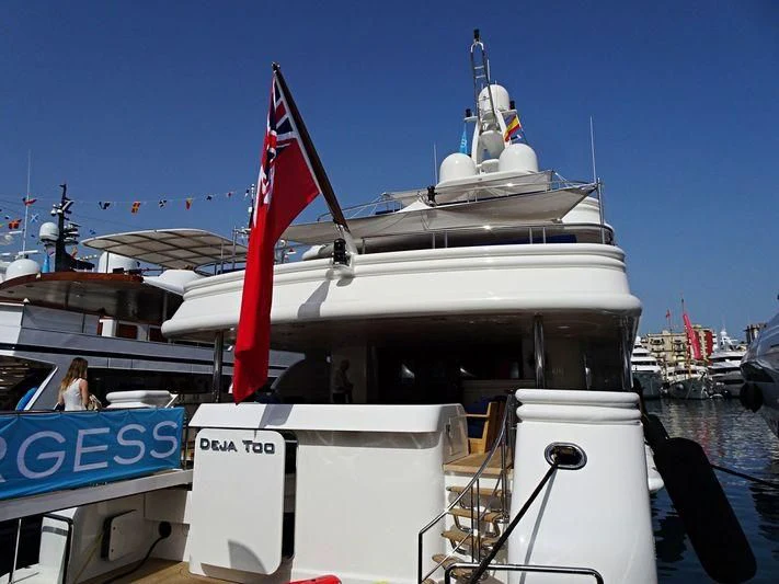 a large white boat with a red sail on it aboard DEJA TOO Yacht for Sale