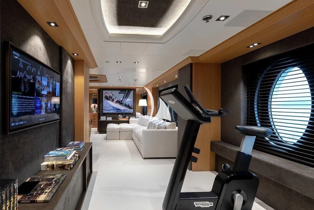 a room with a large television and a couch aboard DEJA TOO Yacht for Sale