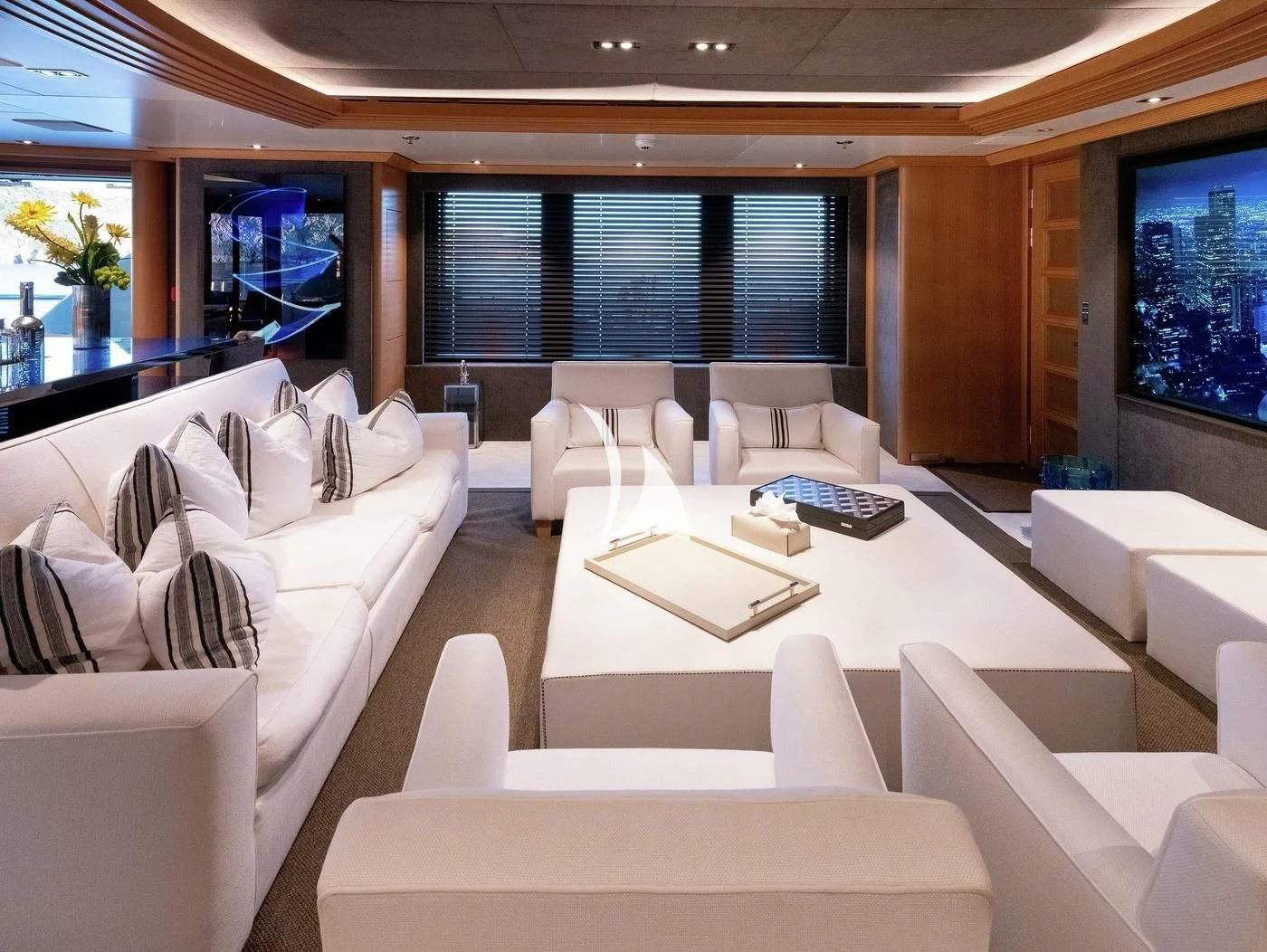 a room with white couches and a table with a large window aboard DEJA TOO Yacht for Sale