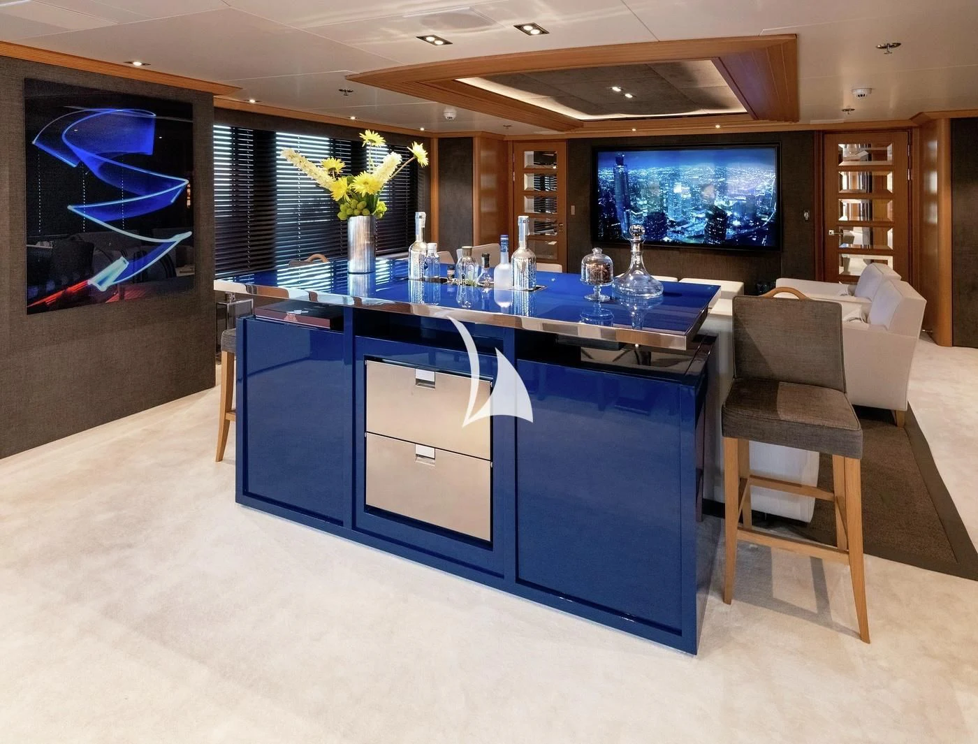 a large kitchen with a bar and chairs aboard DEJA TOO Yacht for Sale