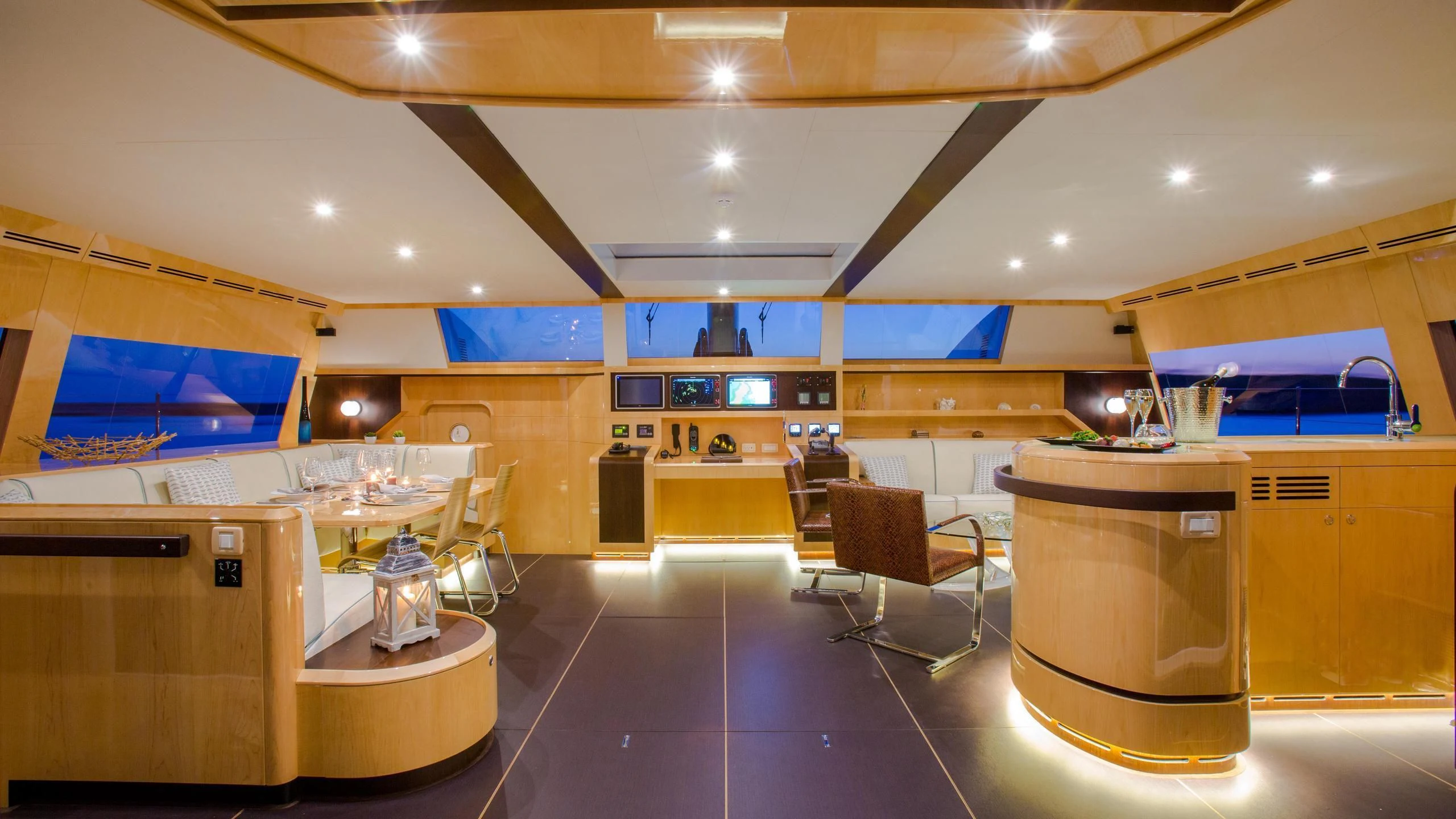 a large kitchen with a bar and seating area aboard WINDQUEST Yacht for Sale