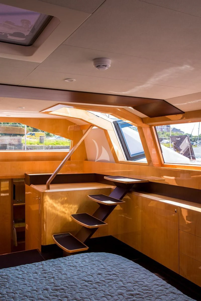 a room with a bed and a table aboard WINDQUEST Yacht for Sale