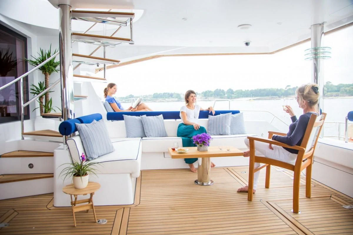 a group of people sitting around a table aboard WINDQUEST Yacht for Sale