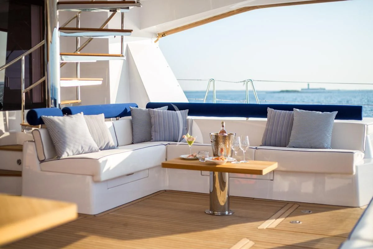 a living room with a couch and a table aboard WINDQUEST Yacht for Sale