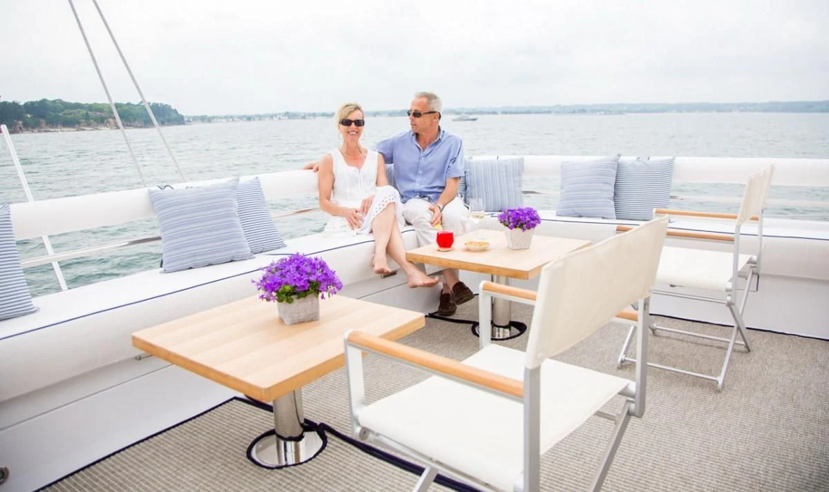 a couple sitting on a boat aboard WINDQUEST Yacht for Sale