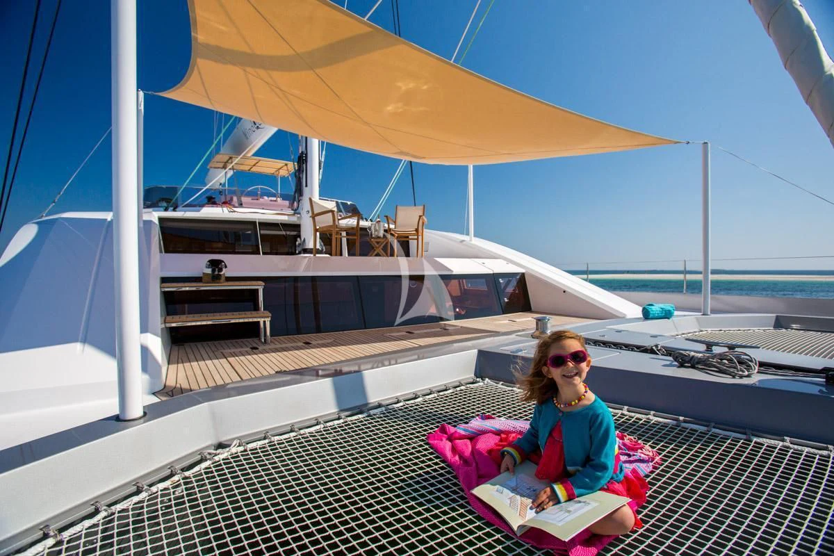 a person sitting on a deck aboard WINDQUEST Yacht for Sale