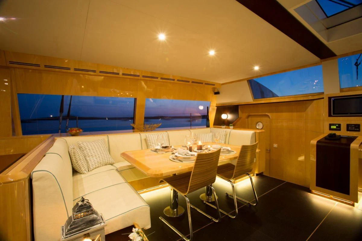 a room with a table and chairs aboard WINDQUEST Yacht for Sale