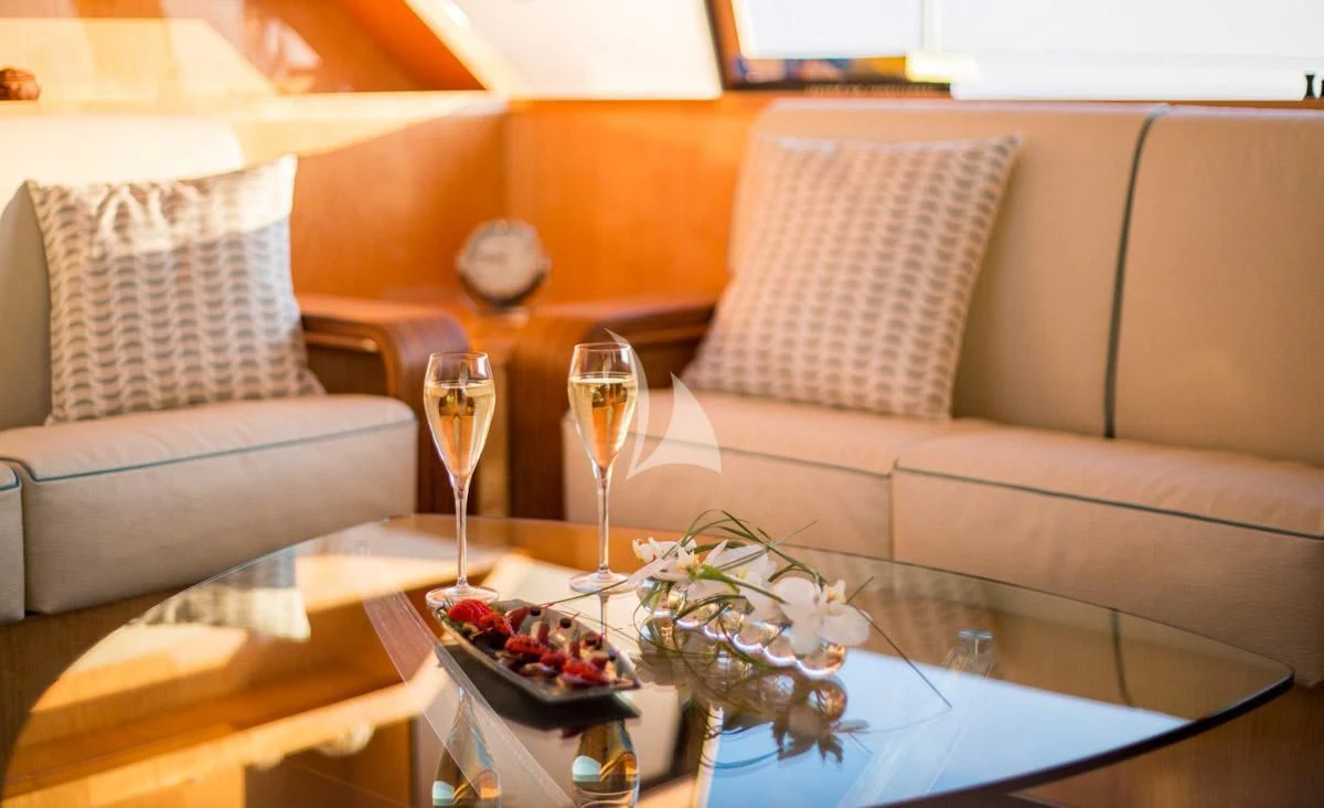 a living room with a couch and coffee table aboard WINDQUEST Yacht for Sale