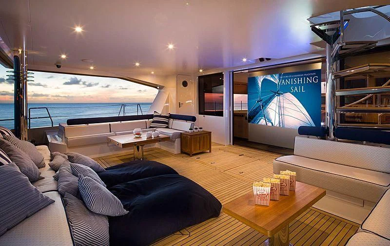 a living room with a large screen aboard WINDQUEST Yacht for Sale