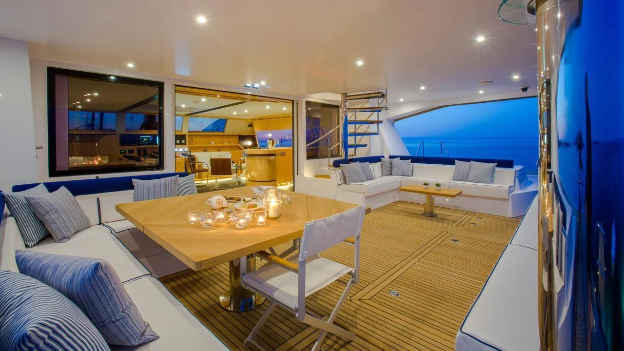 a living room with a table and chairs aboard WINDQUEST Yacht for Sale