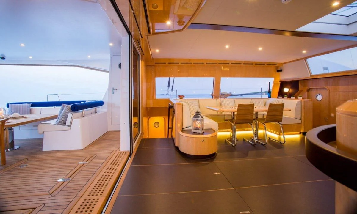 a room with a table and chairs aboard WINDQUEST Yacht for Sale