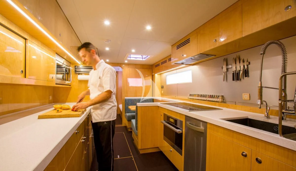 a man in a kitchen aboard WINDQUEST Yacht for Sale