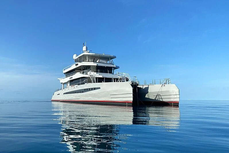 a large white ship in the water aboard MAGNET Yacht for Sale