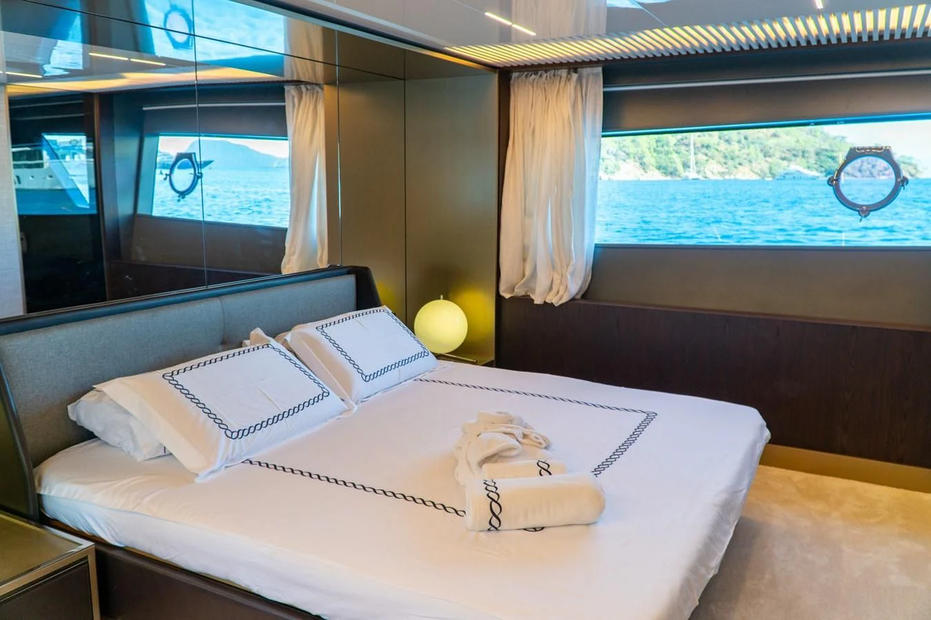 a bed with a white sheet and pillows aboard LADY G Yacht for Sale