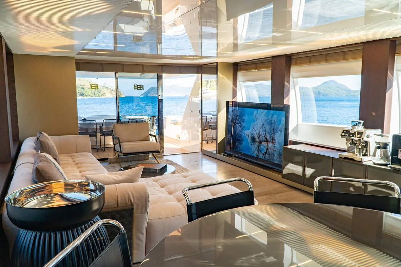 a living room with a large screen aboard LADY G Yacht for Sale