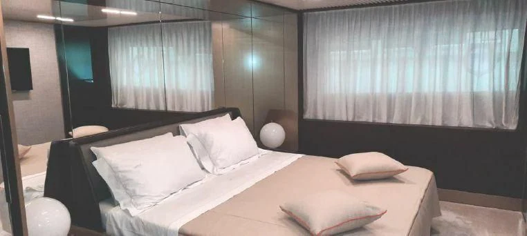 a room with a bed and a window aboard LADY G Yacht for Sale