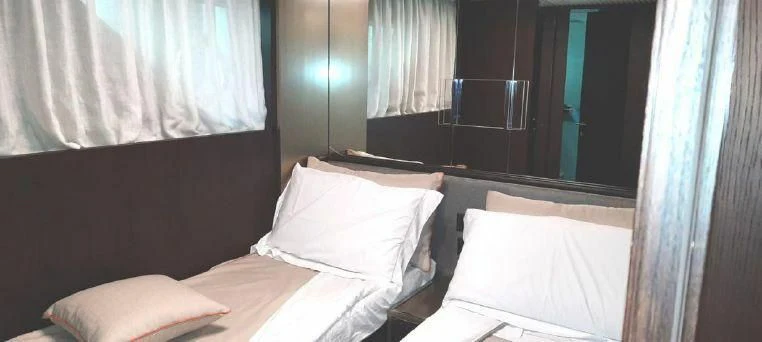 a room with a bed and a window aboard LADY G Yacht for Sale
