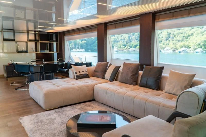 a living room with a couch and a table aboard LADY G Yacht for Sale