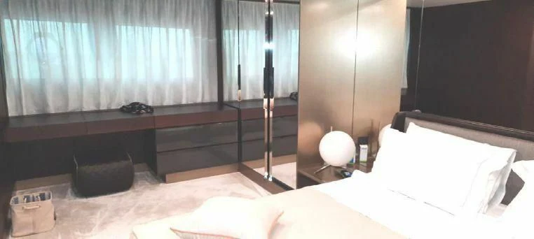 a bed with a chair and a television in the background aboard LADY G Yacht for Sale