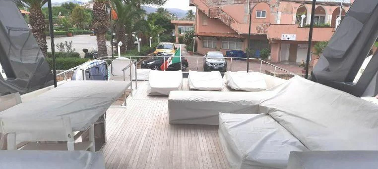 a patio with a group of couches and chairs on it aboard LADY G Yacht for Sale