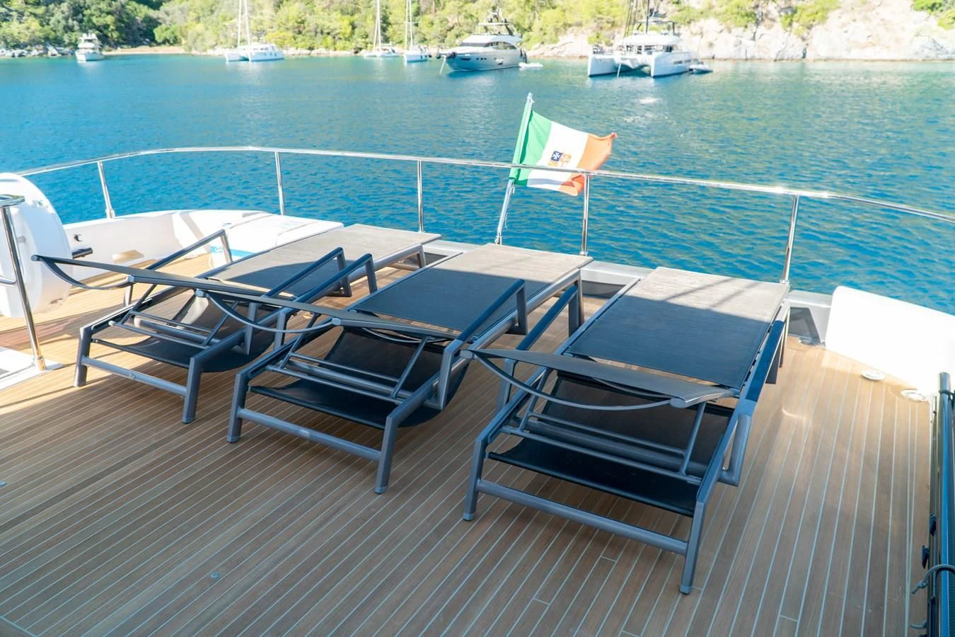 a group of chairs on a deck overlooking a body of water aboard LADY G Yacht for Sale