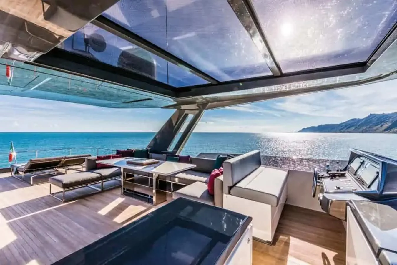 a room with a pool and a deck with a view of the ocean aboard LADY G Yacht for Sale