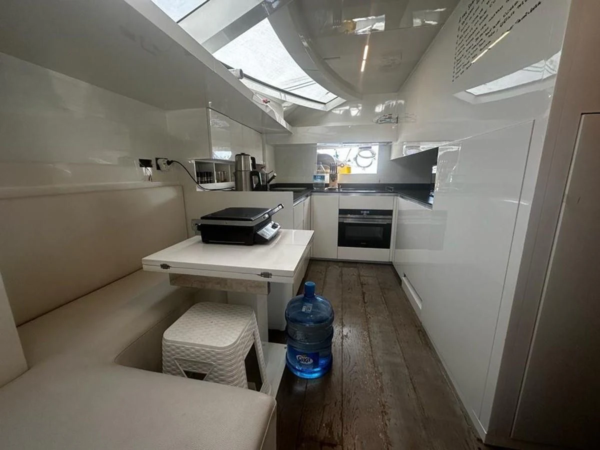 a room with a bed and a table aboard LADY G Yacht for Sale
