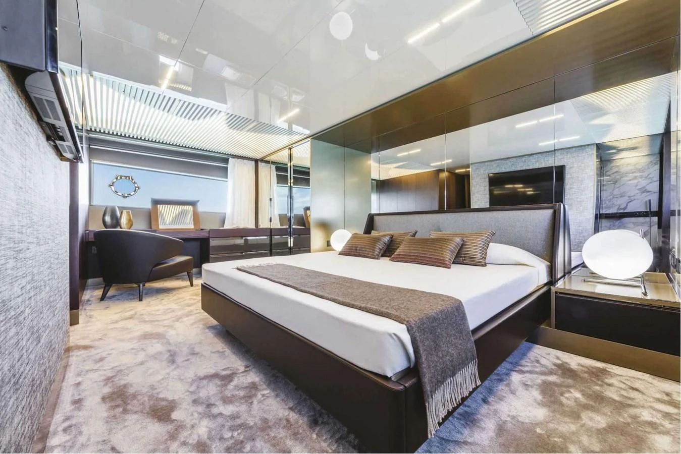 a bedroom with a bed and a chair aboard LADY G Yacht for Sale