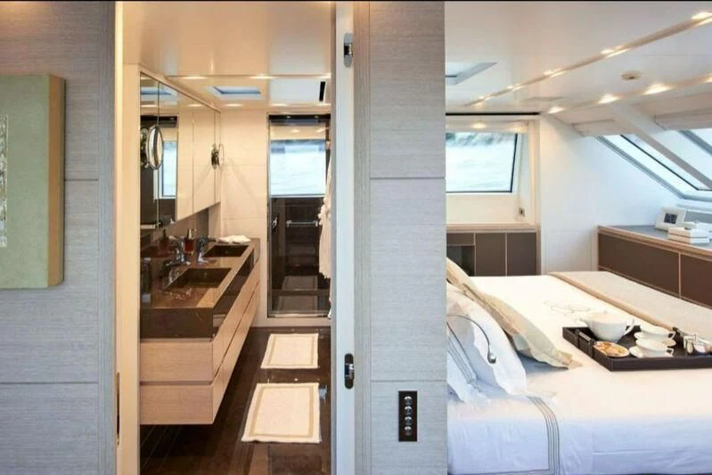 a bedroom with a bed and sink aboard NAYA 7 Yacht for Sale