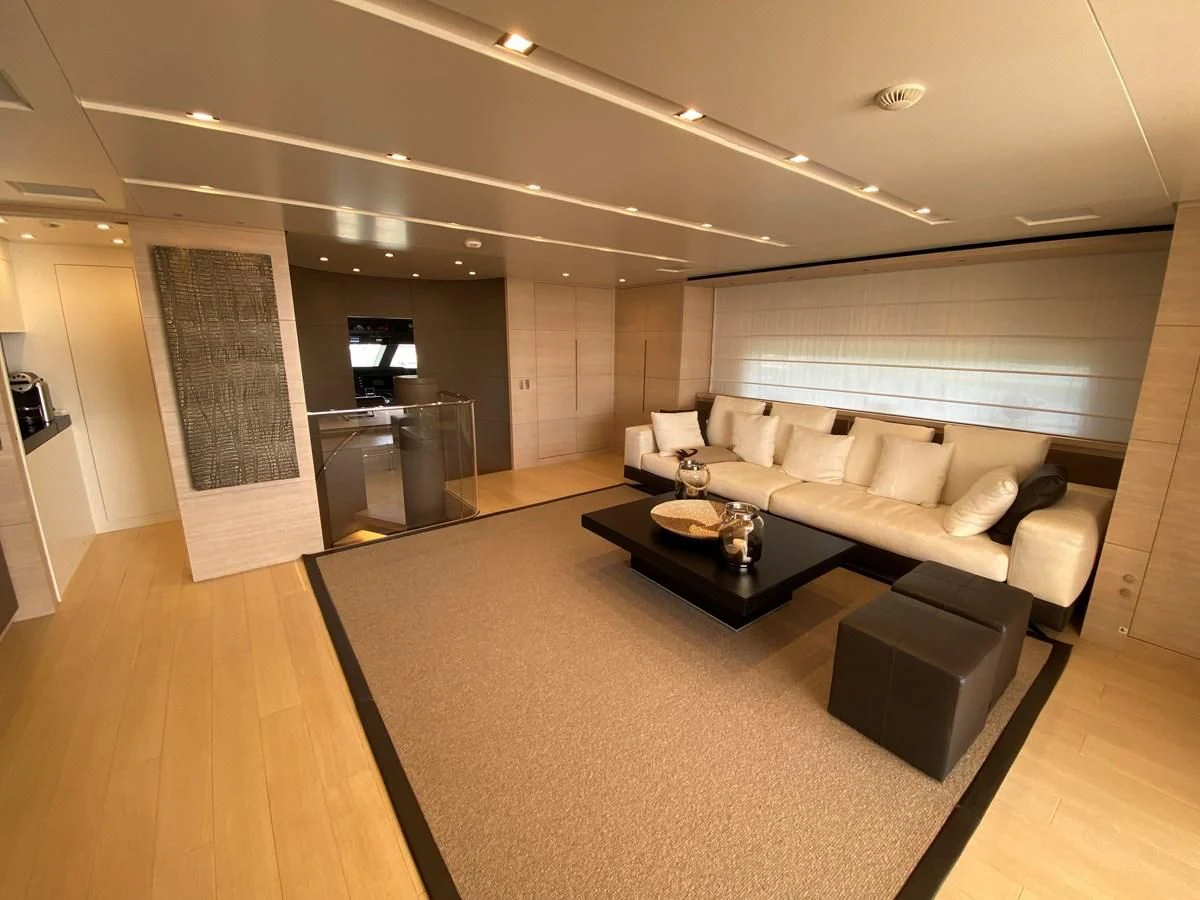 a living room with a couch and a table aboard NAYA 7 Yacht for Sale