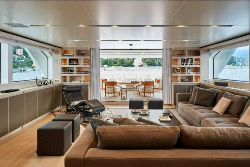 a living room with a couch and a table aboard NAYA 7 Yacht for Sale