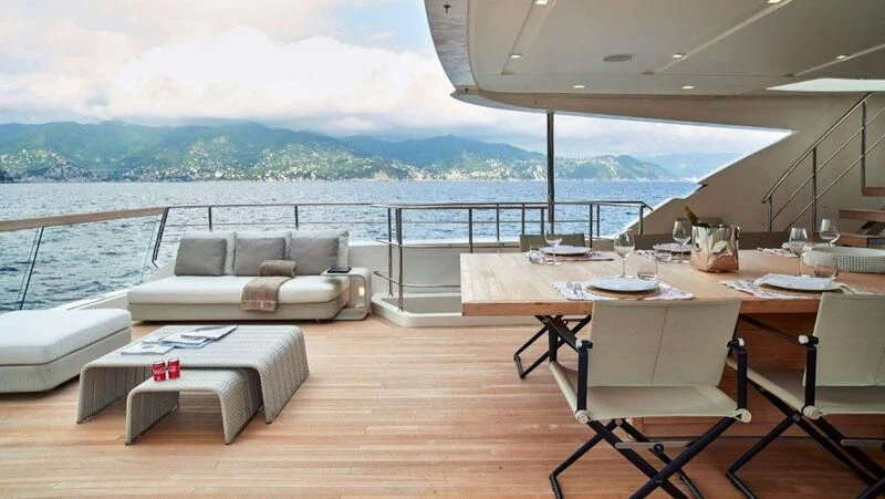 a room with a couch and a table and a view of the ocean aboard NAYA 7 Yacht for Sale