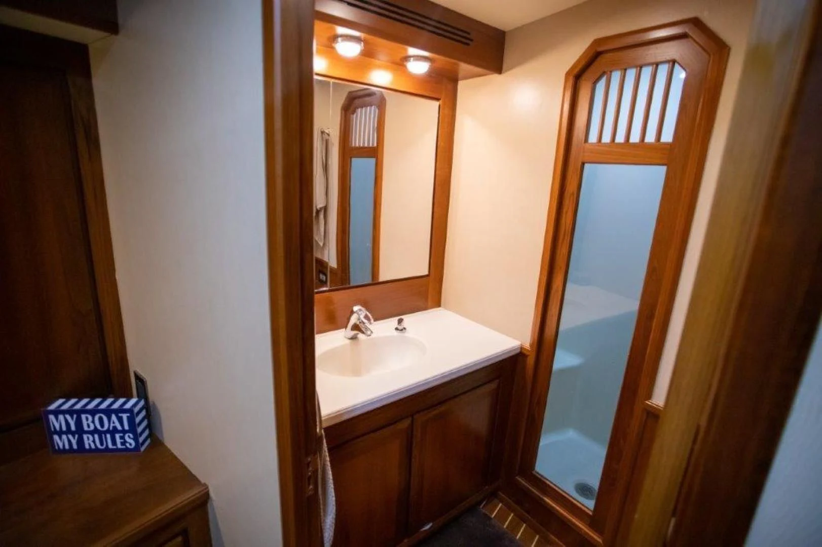 a bathroom with a sink and a mirror aboard PULLIN WIRE Yacht for Sale