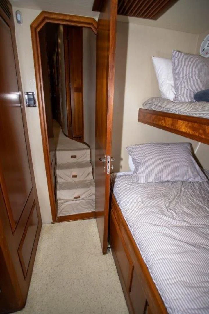 a bedroom with a bed and a closet aboard PULLIN WIRE Yacht for Sale