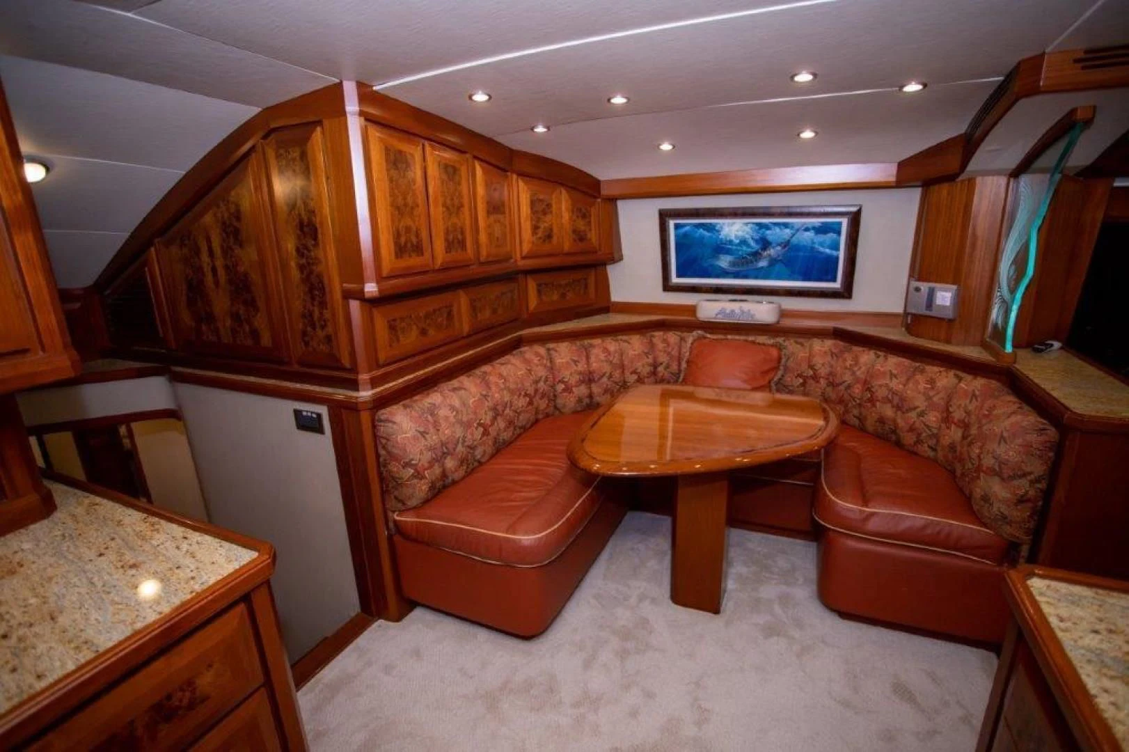 a living room with a table and couches aboard PULLIN WIRE Yacht for Sale
