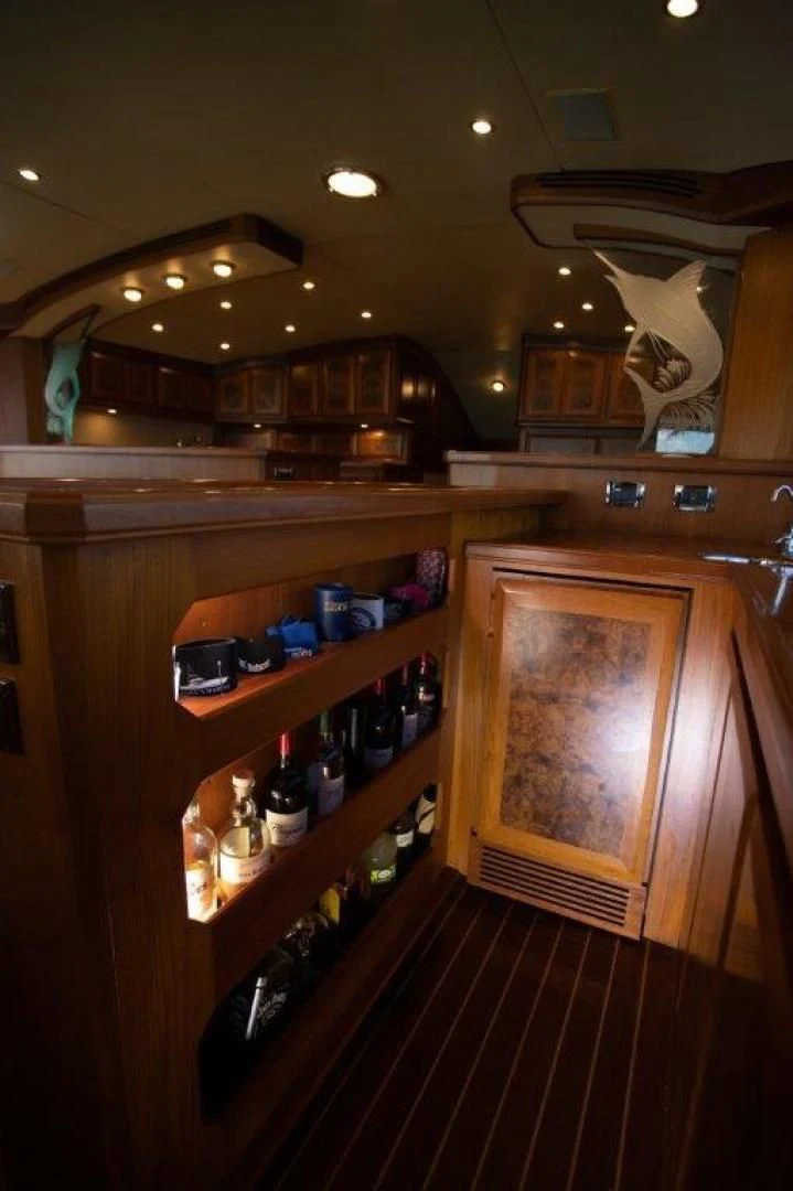 a wooden cabinet with bottles and glasses aboard PULLIN WIRE Yacht for Sale