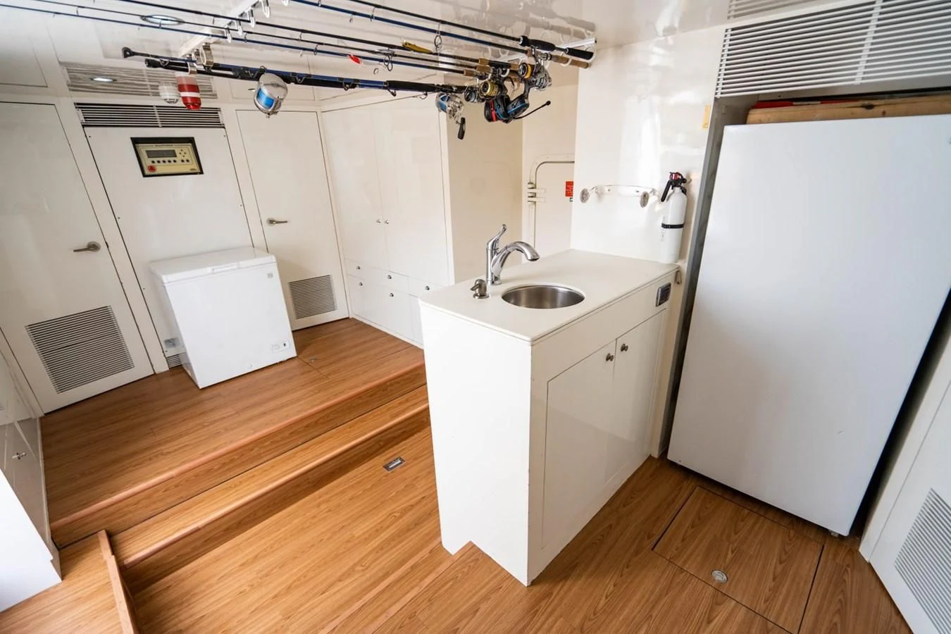 a kitchen with white cabinets aboard TRUE NORTH Yacht for Sale
