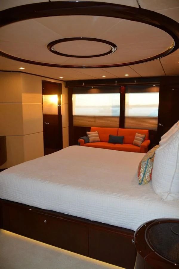 a bed with a white bed spread aboard TRUE NORTH Yacht for Sale