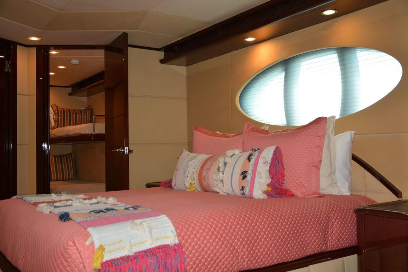 a bed with a pink comforter aboard TRUE NORTH Yacht for Sale