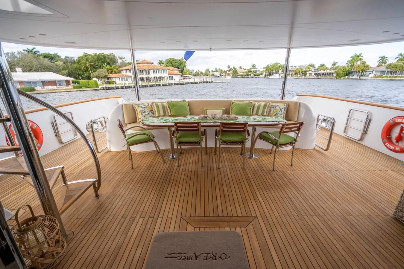 a deck with tables and chairs aboard TRUE NORTH Yacht for Sale