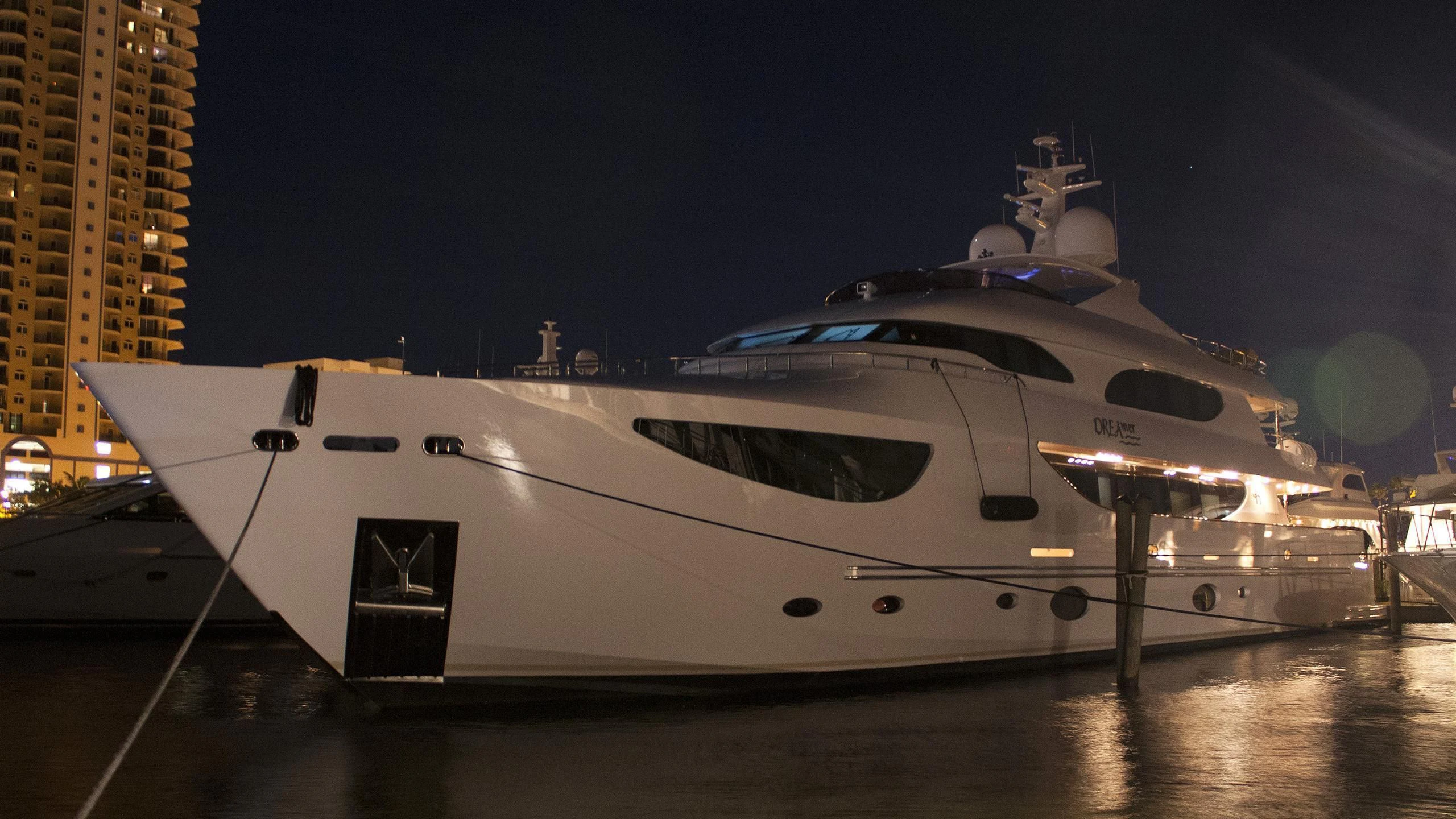 a white yacht at night aboard TRUE NORTH Yacht for Sale