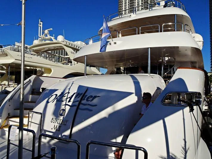 a large white boat with a person on it aboard TRUE NORTH Yacht for Sale