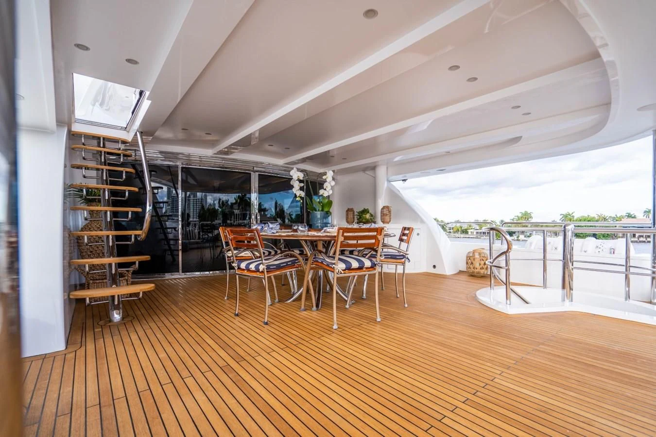 a room with a wood floor and chairs and a wood floor aboard TRUE NORTH Yacht for Sale
