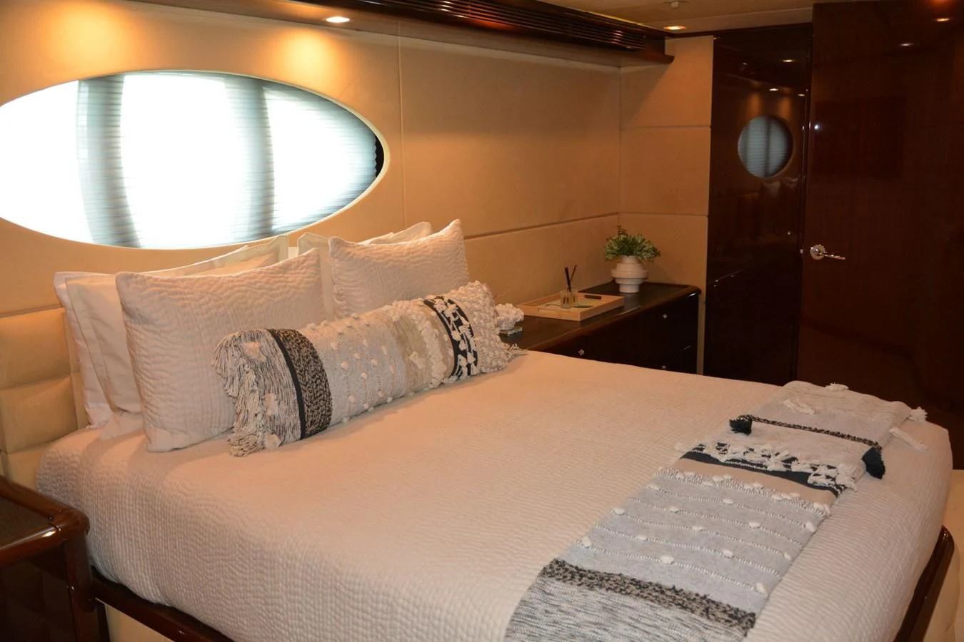 a bed with a white bed spread aboard TRUE NORTH Yacht for Sale