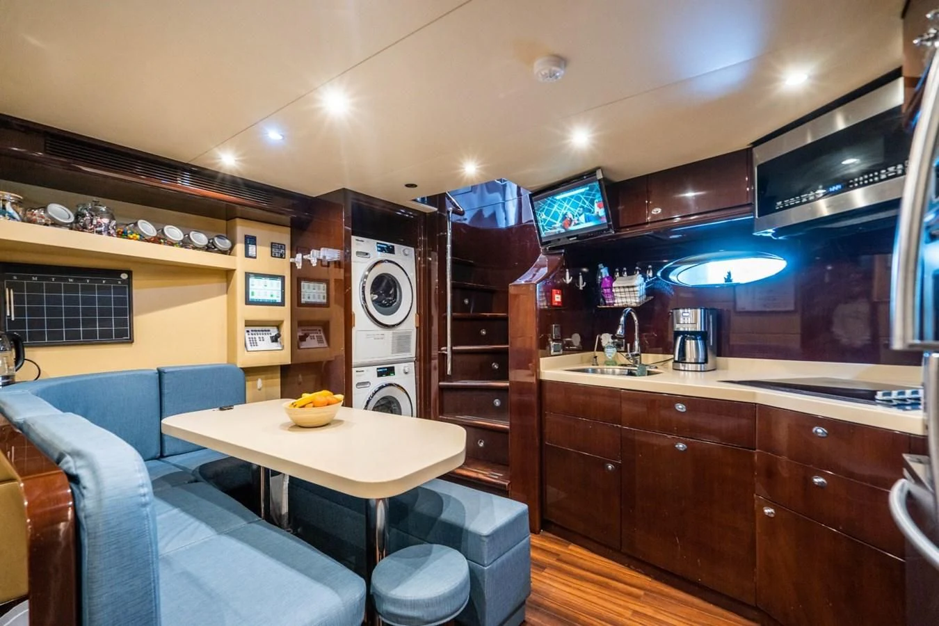 a kitchen with a table and chairs aboard TRUE NORTH Yacht for Sale