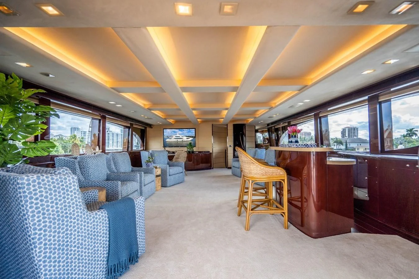 a room with blue chairs and a table with a large window aboard TRUE NORTH Yacht for Sale