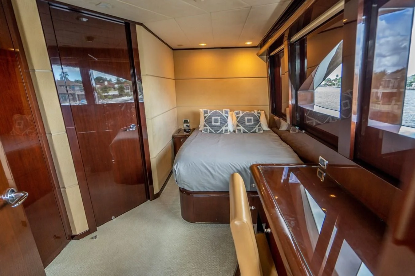 a bedroom with a bed and a mirror aboard TRUE NORTH Yacht for Sale