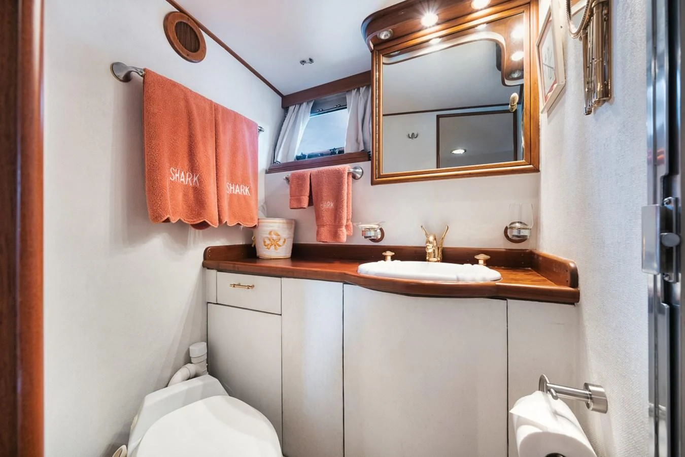 a bathroom with a mirror and towels aboard SHARK Yacht for Sale